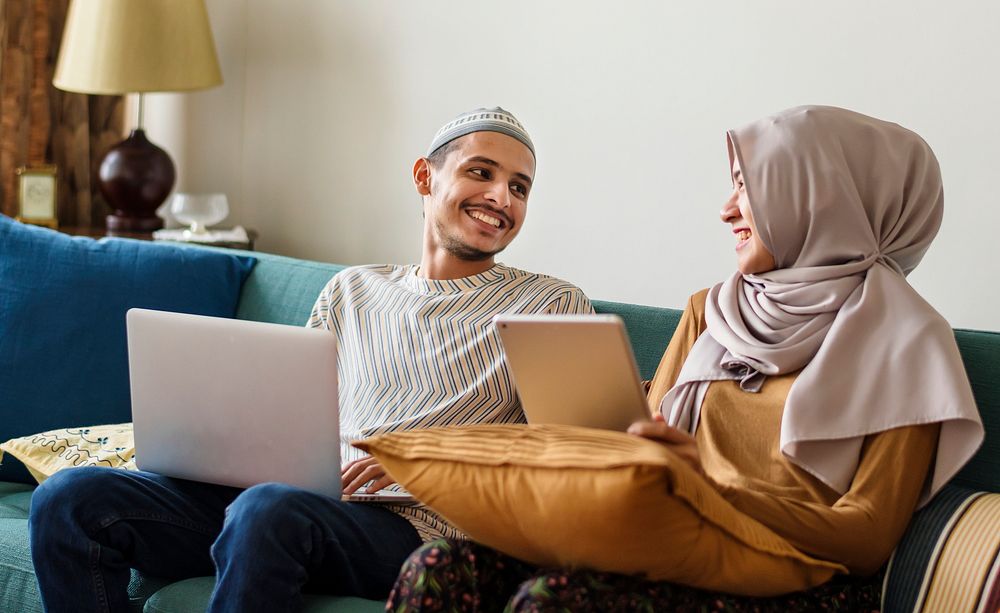 Muslim family using digital devices at home
