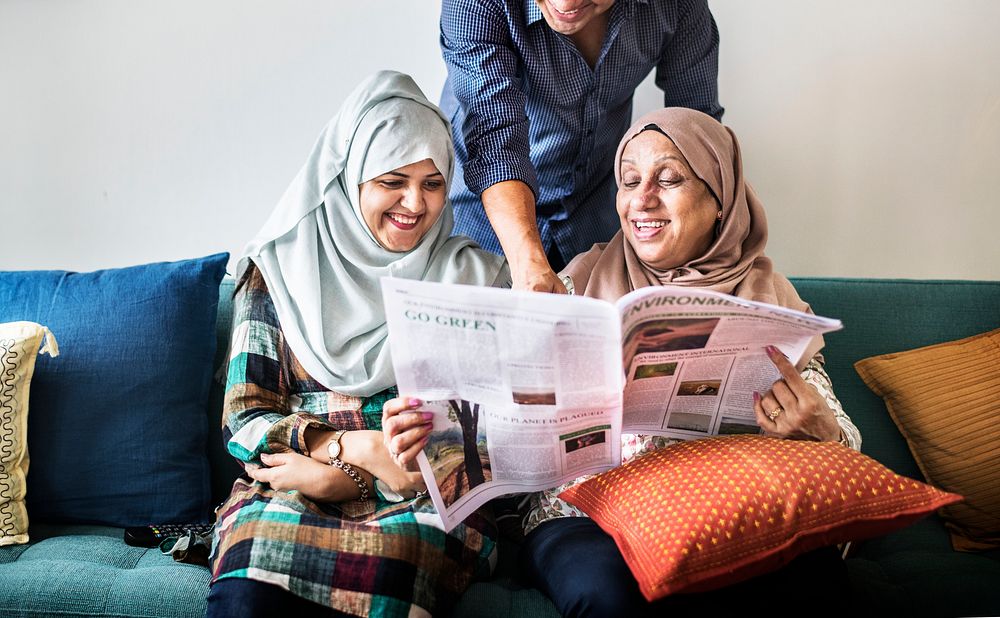 Muslim family reading the news