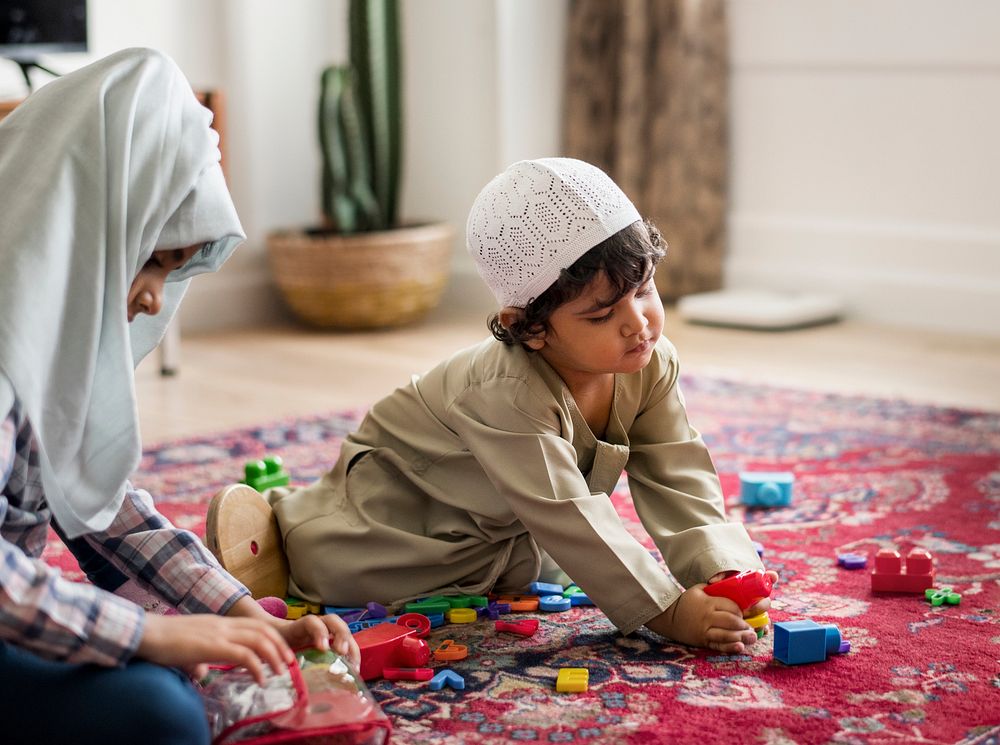 Muslim family relaxing and playing at home
