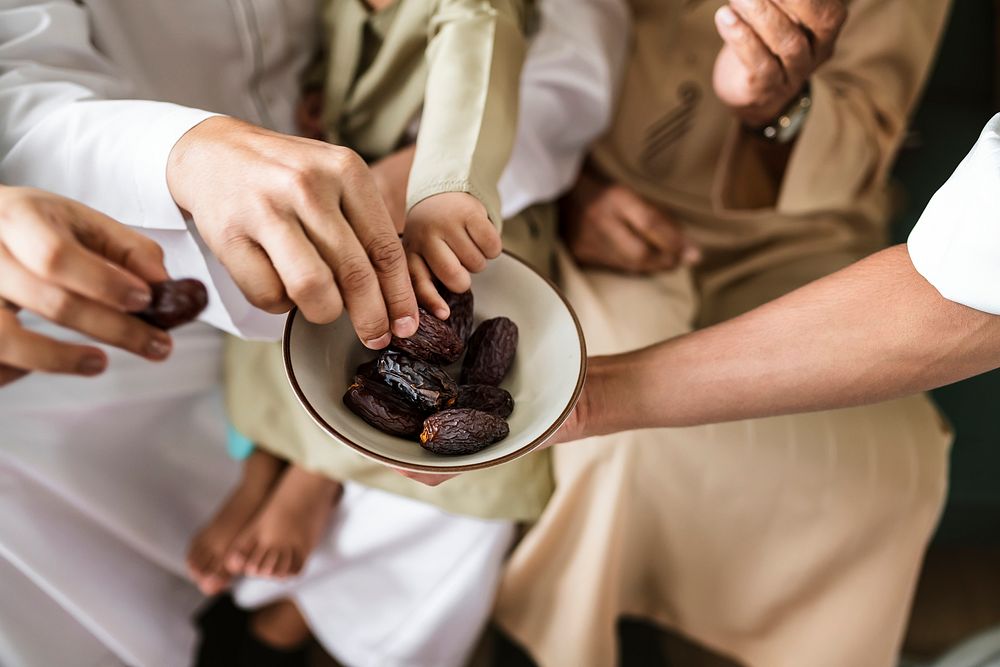 People sharing some dried dates