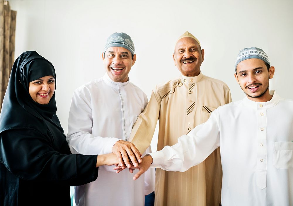 Muslim group of friends stacking hands