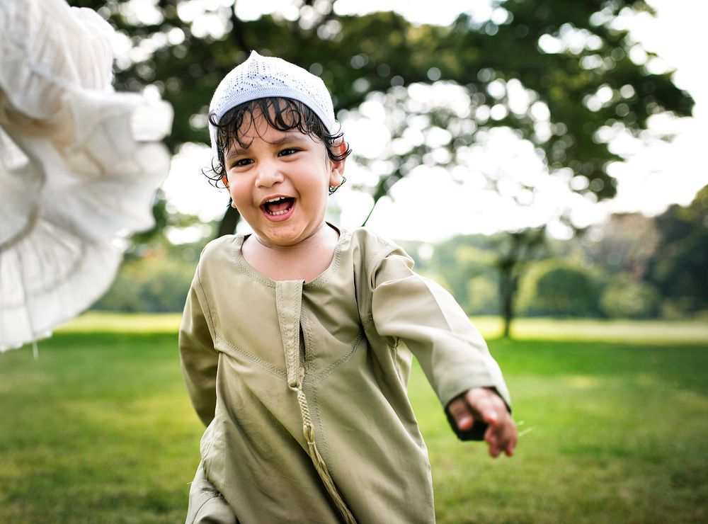 Muslim brother and sister playing in the park