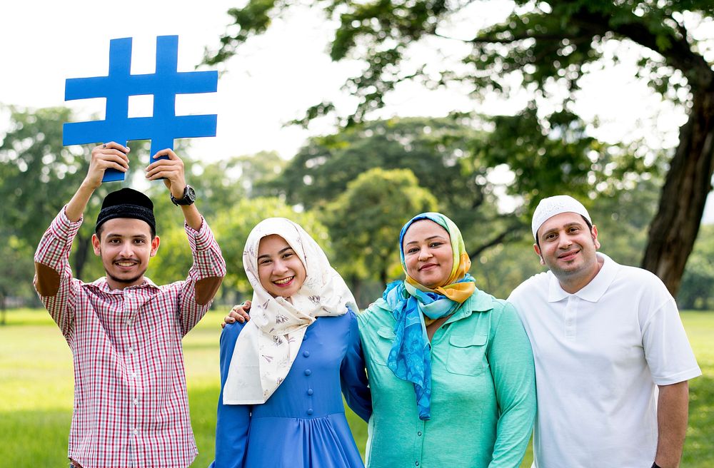 Muslim family holding up a hashtag