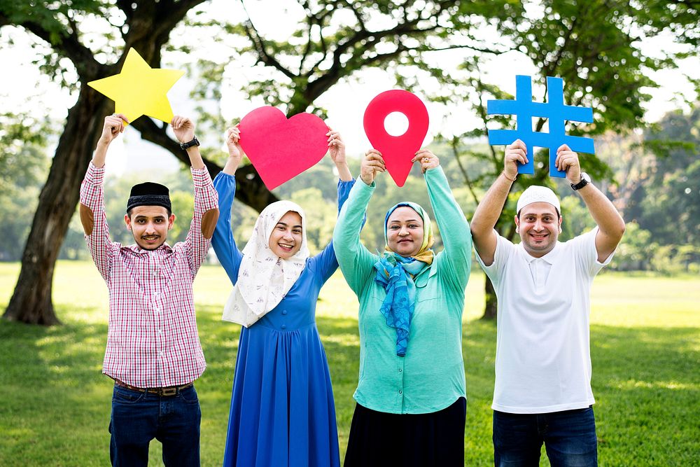 Muslim family holding up various social media icons