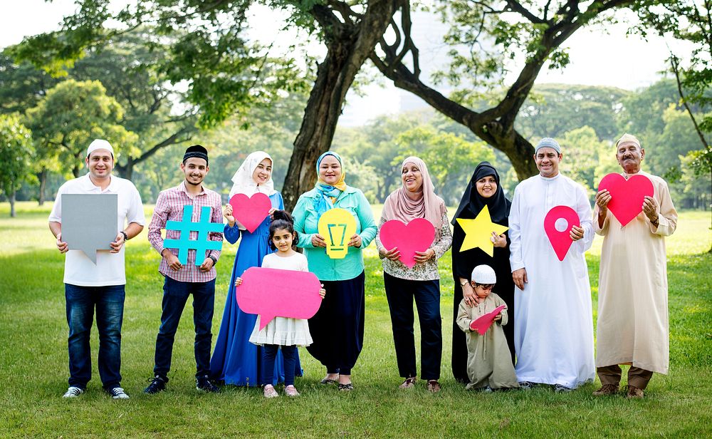 Muslim family holding up various social media icons
