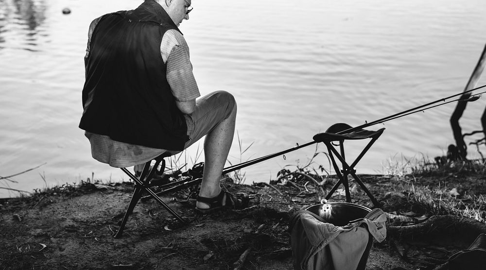 Senior man fishing by a lake