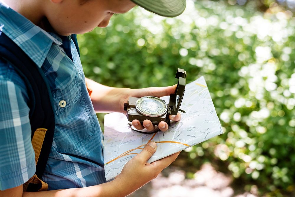 Boy following the directions of a compass