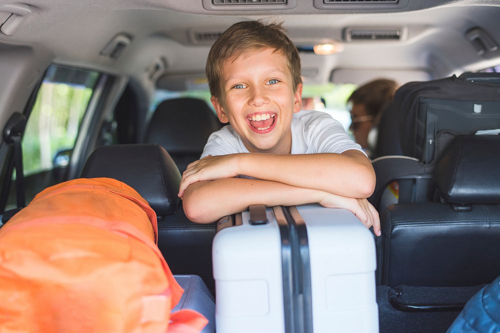 Little boy going on a holiday by car