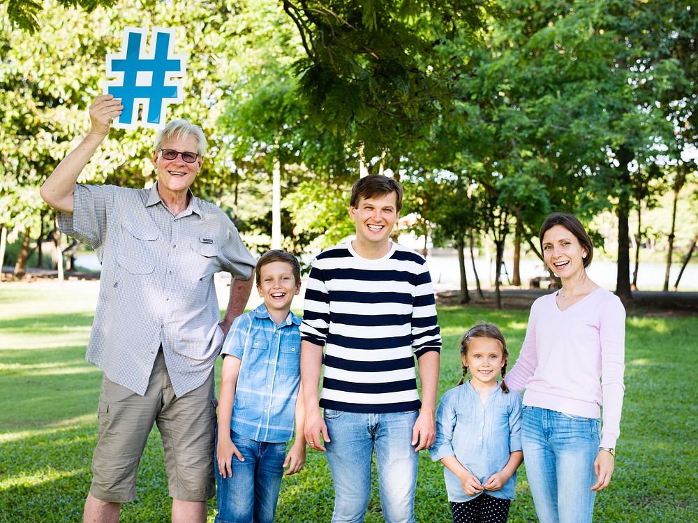 Happy family holding up hashtags