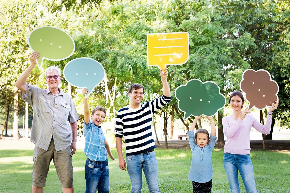 Happy family holding up speech bubbles