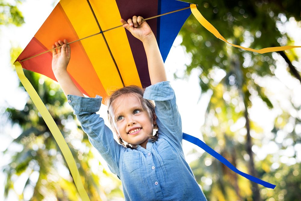 Girl playing with a colorful kite