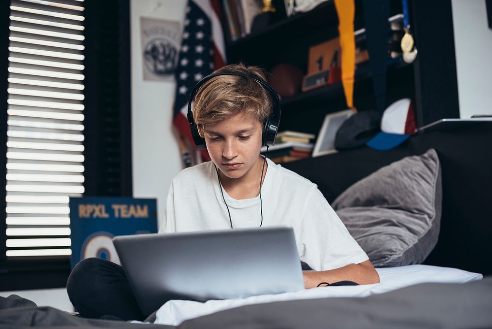Young boy playing on his laptop