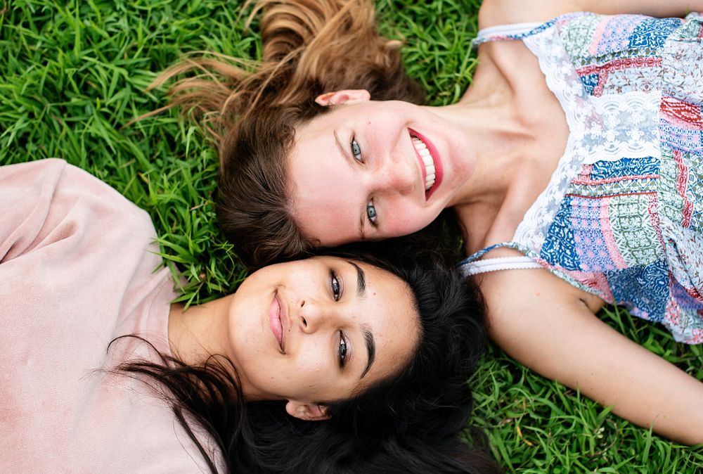 Girl friends lying on the grass