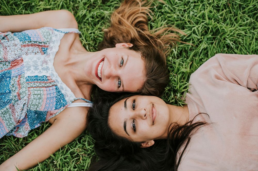 Girl friends lying on the grass
