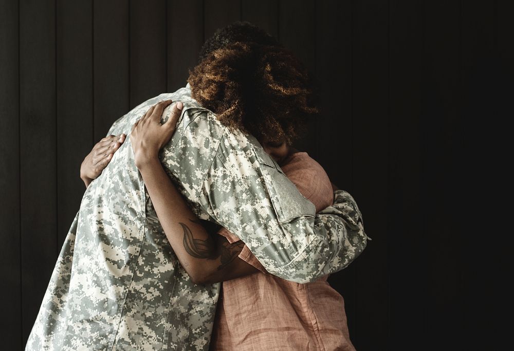 Military husband hugging his wife
