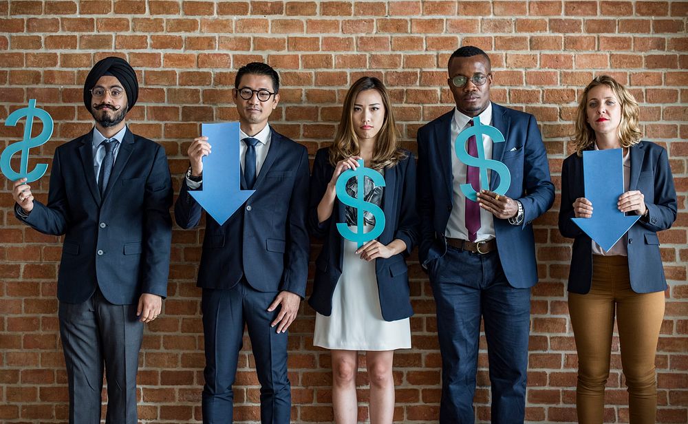 Diverse office workers holding currency depreciation symbols