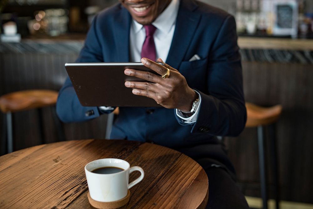 Businessman in a cafe using a tablet