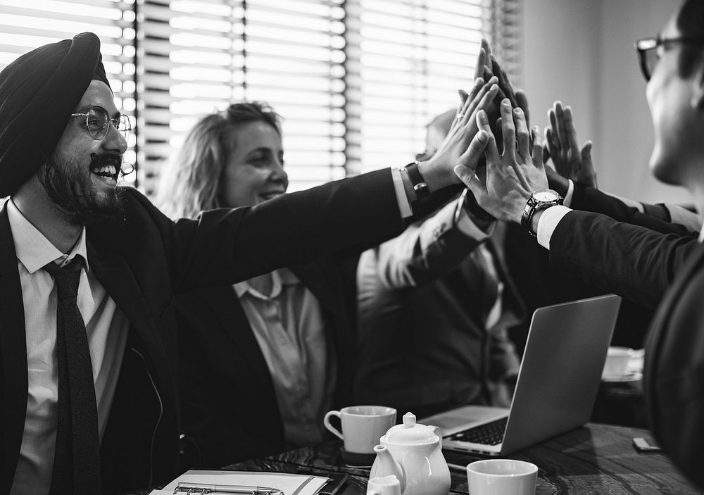 Business people doing a group high five