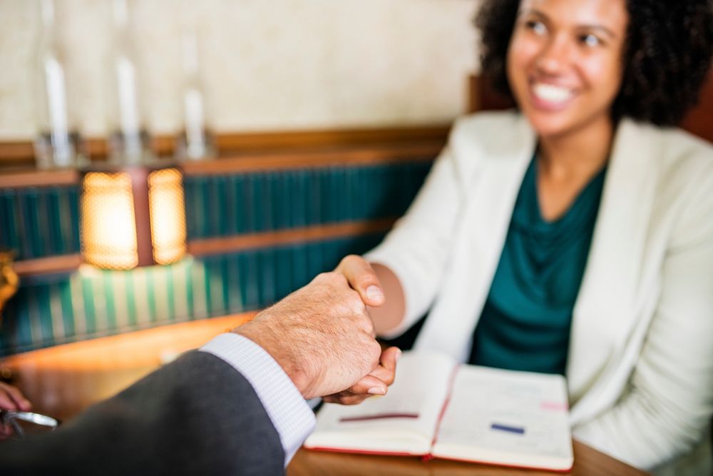 Woman shaking hands with business partner