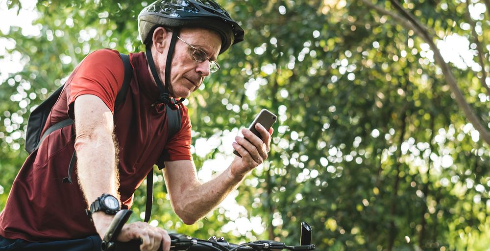 Senior cyclist using the gps on his phone