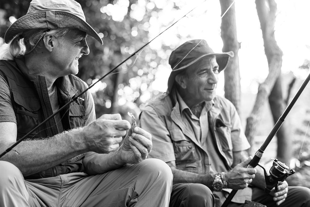 Senior friends fishing by the lake
