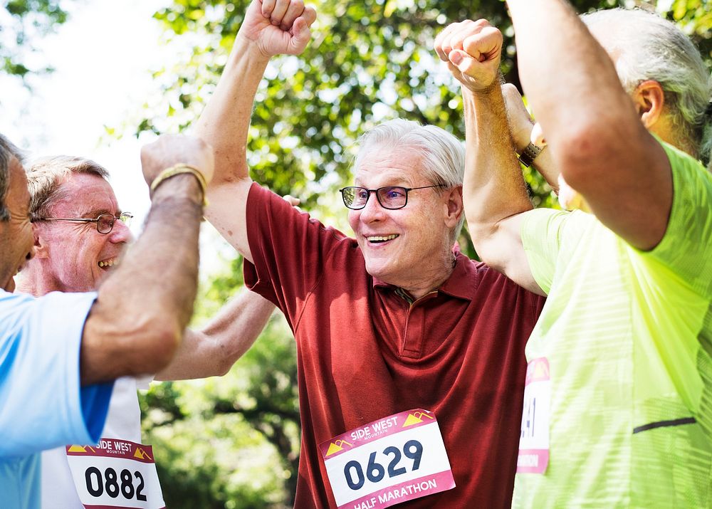 Group of cheerful senior runners at the park