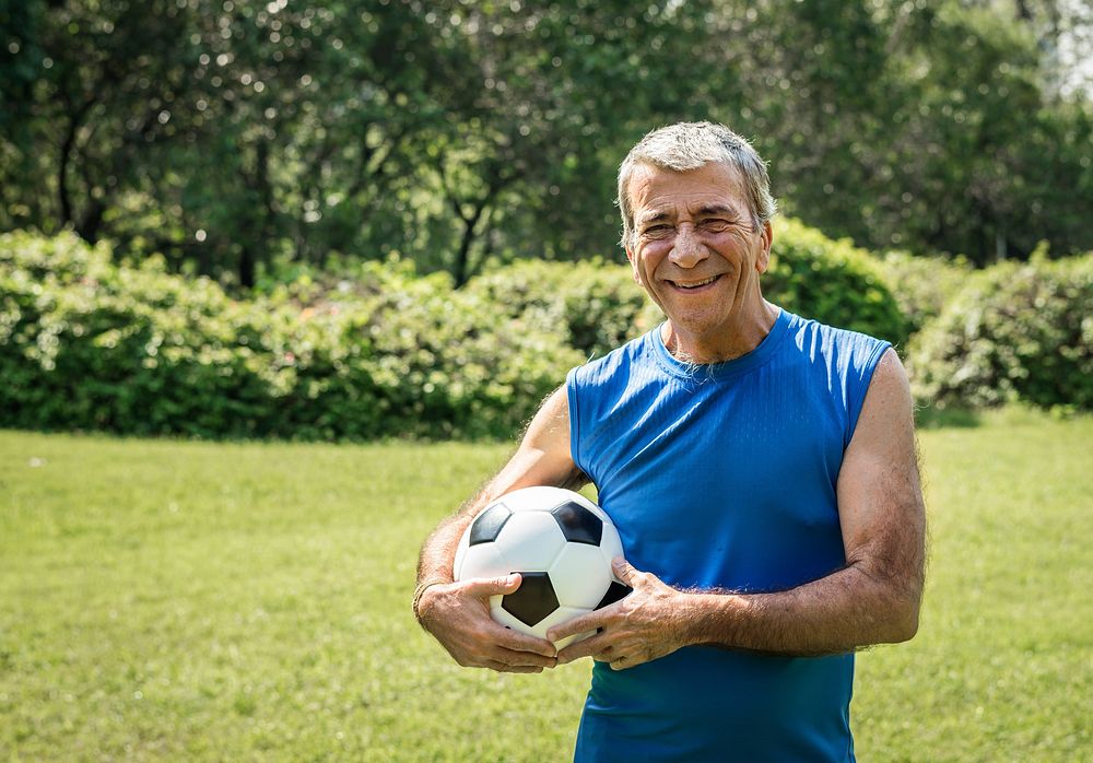 Mature man holding a football