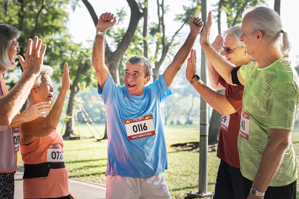 Group of cheerful senior runners at the park