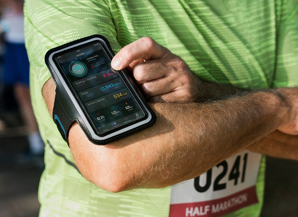 Senior runner using a fitness tracker application