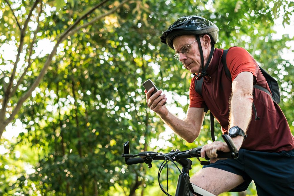 Senior cyclist using gps on mobile phone