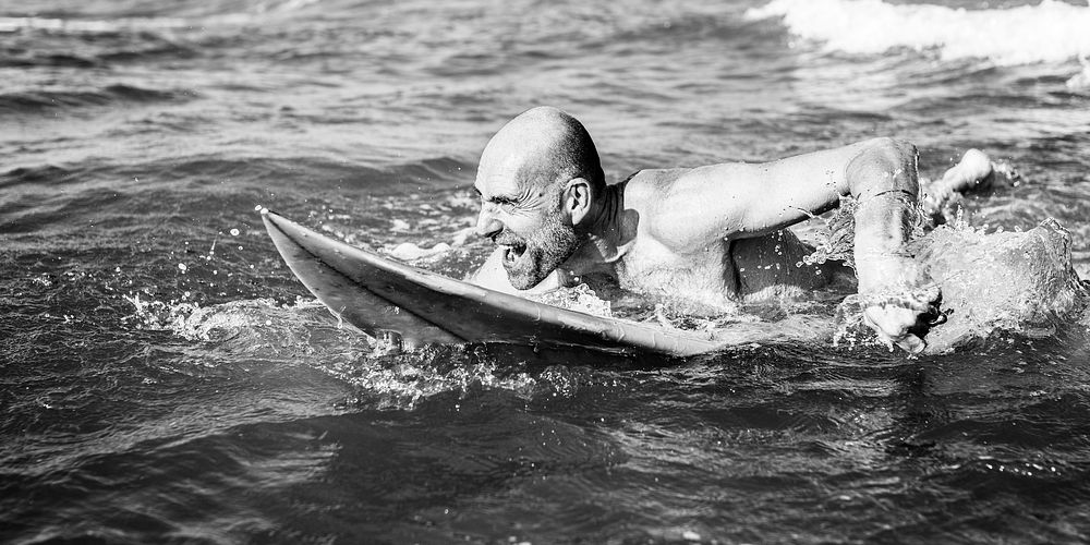 Senior man on a surfboard