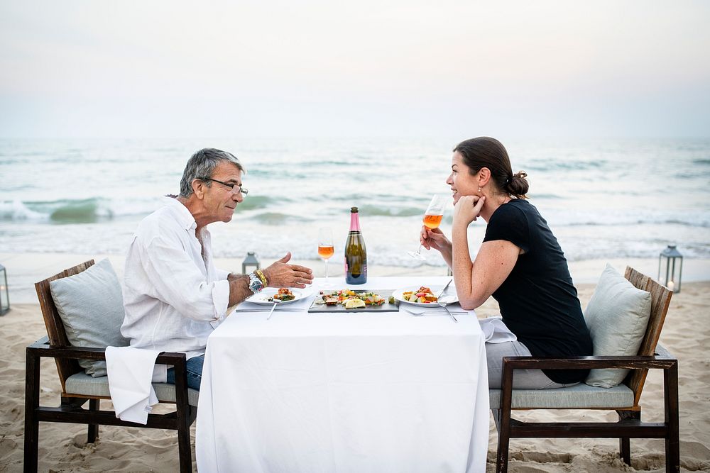 Couple enjoying a romantic dinner at the beach