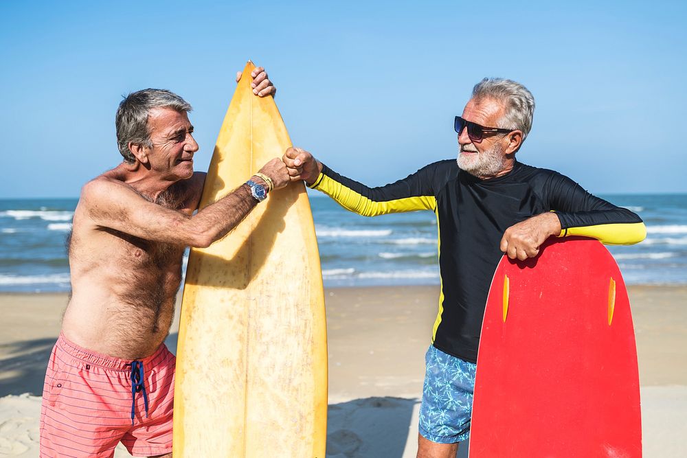 Senior men with surfboards