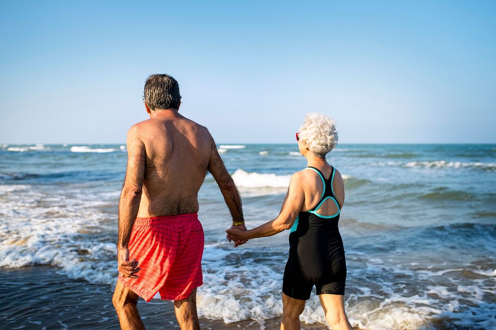 Mature couple walking into the water