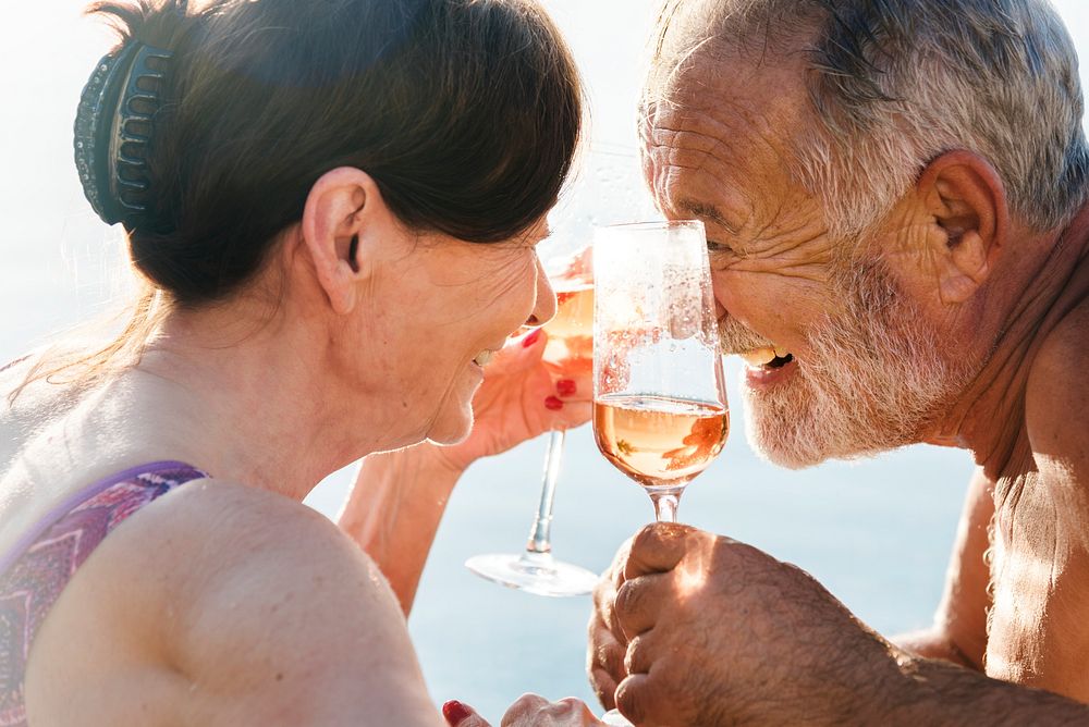 Mature couple celebrating with prosecco