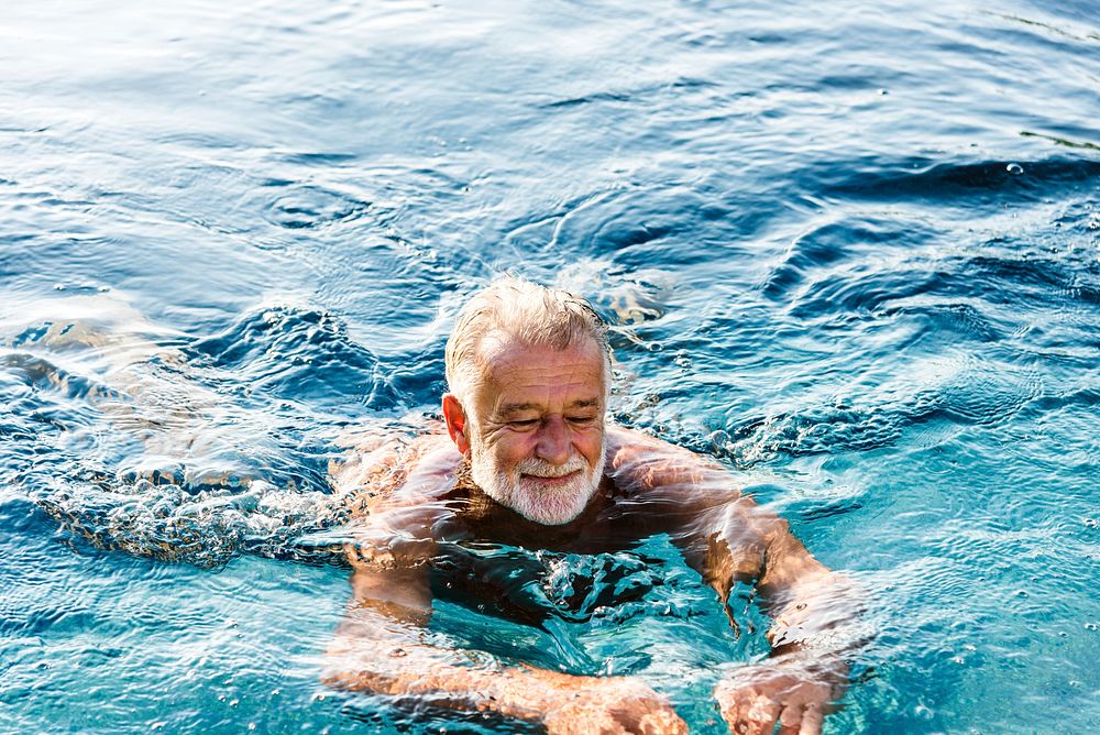 Senior man chilling in swimming pool