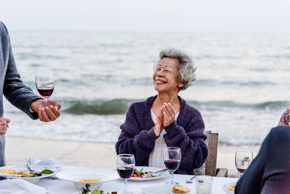 Seniors having a dinner party at the beach