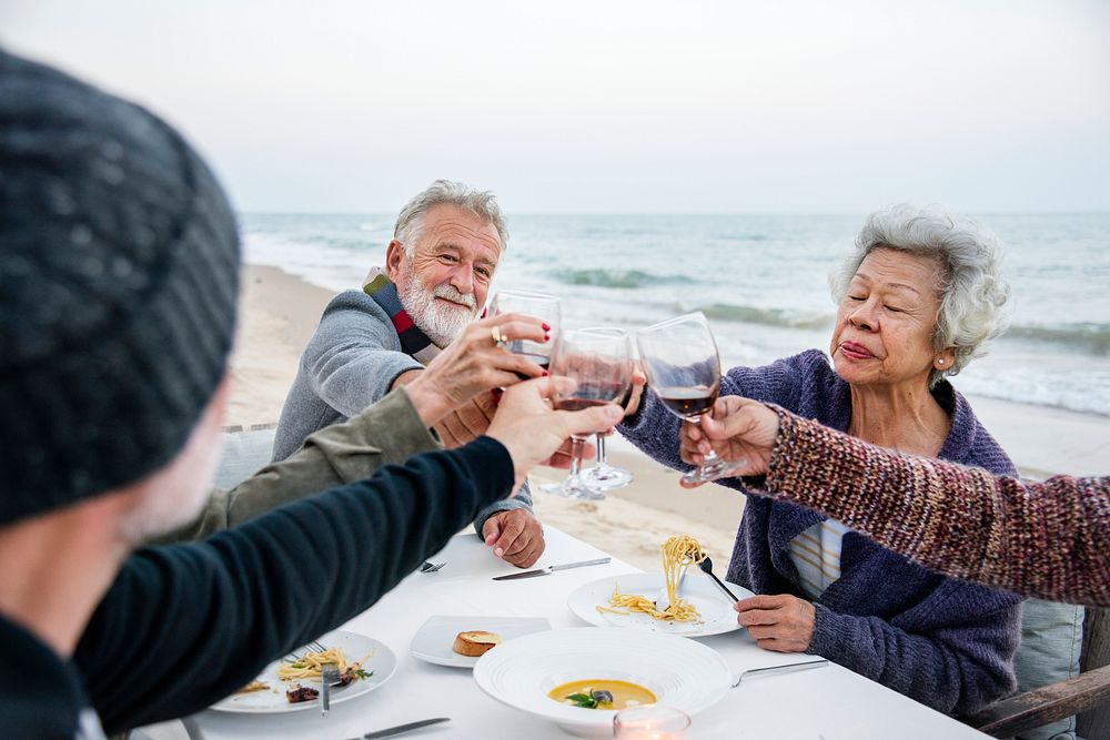 Seniors having a dinner party at the beach