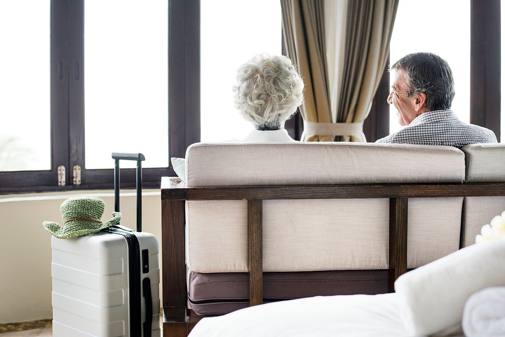 Senior couple sitting in a hotel room