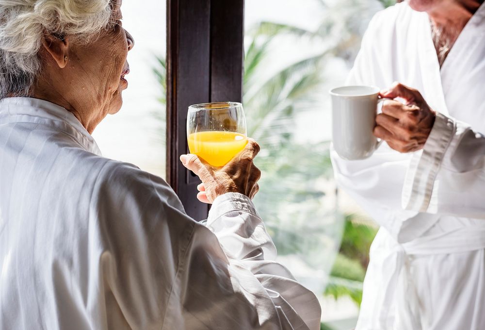 Senior couple having breakfast in a hotel room