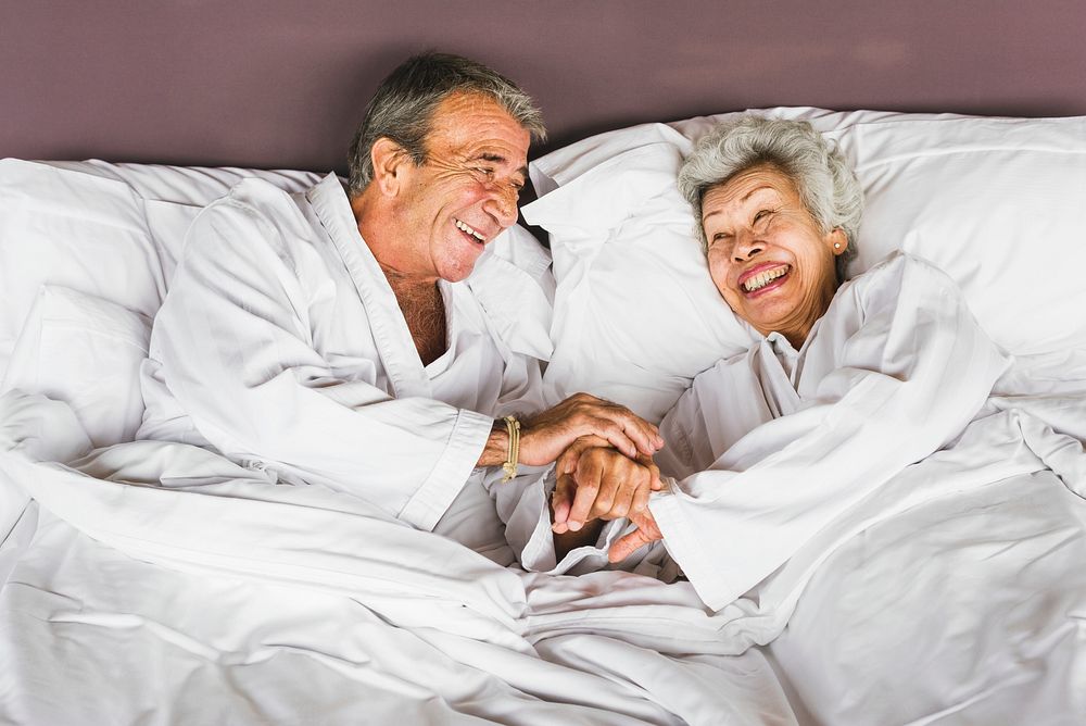 Senior couple lying in bed