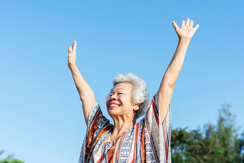 Senior woman raising her hands