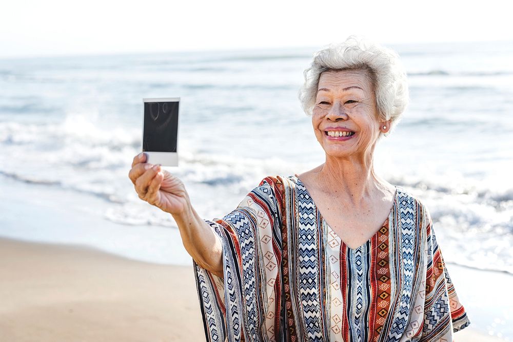 Senior asian woman holding a photograph