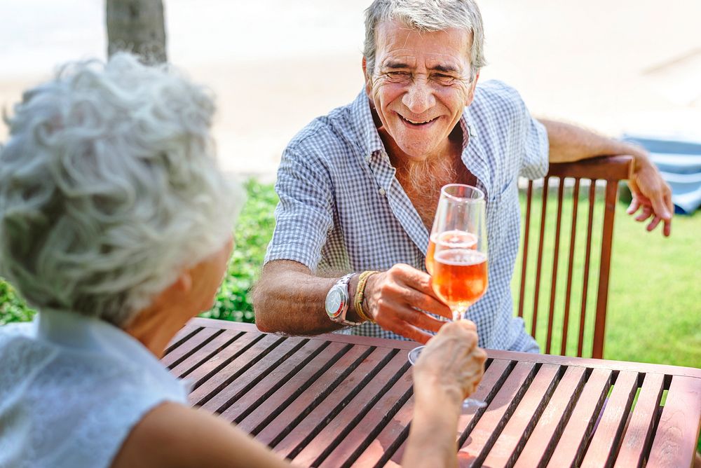 Mature couple celebrating with prosecco