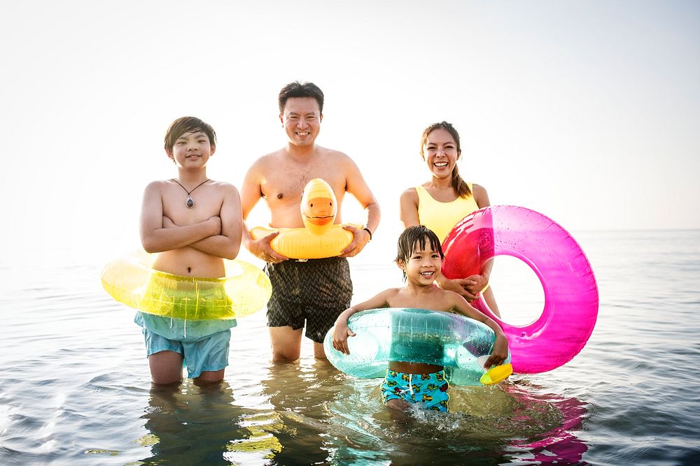 Asian family playing at the beach
