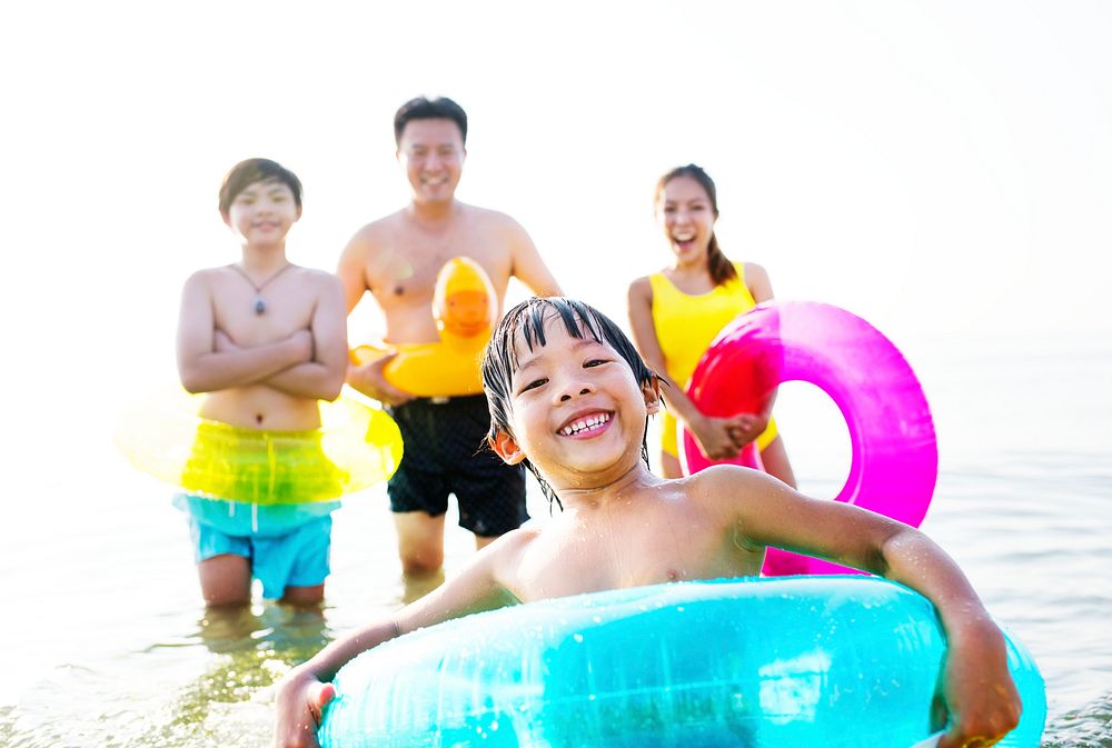 A cheerful kid in a float tube swimming