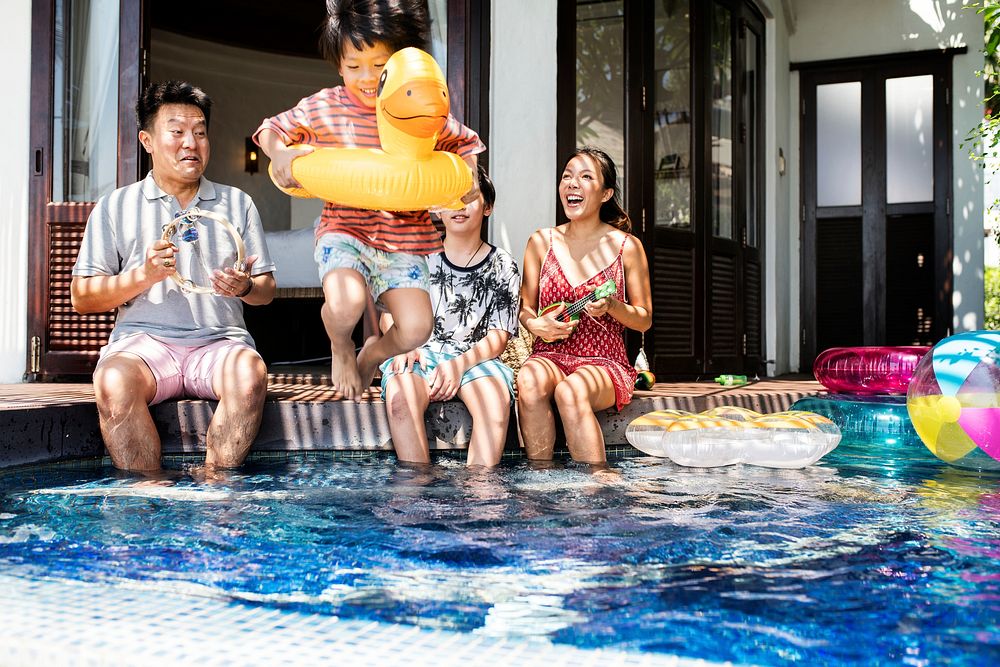 Family playing in a pool