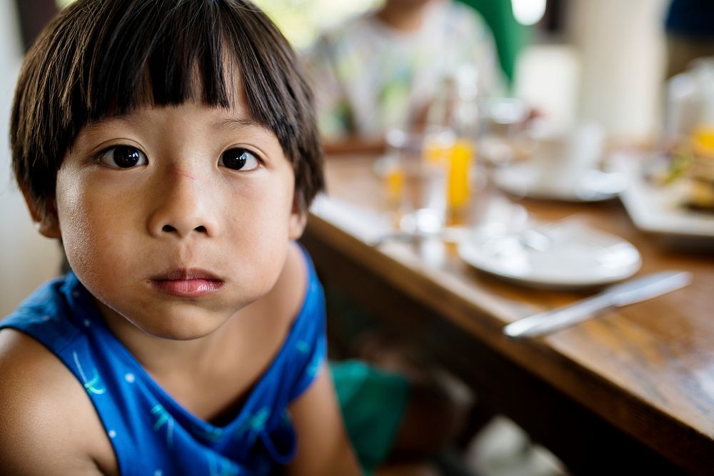 Young boy sitting at a restaurant table