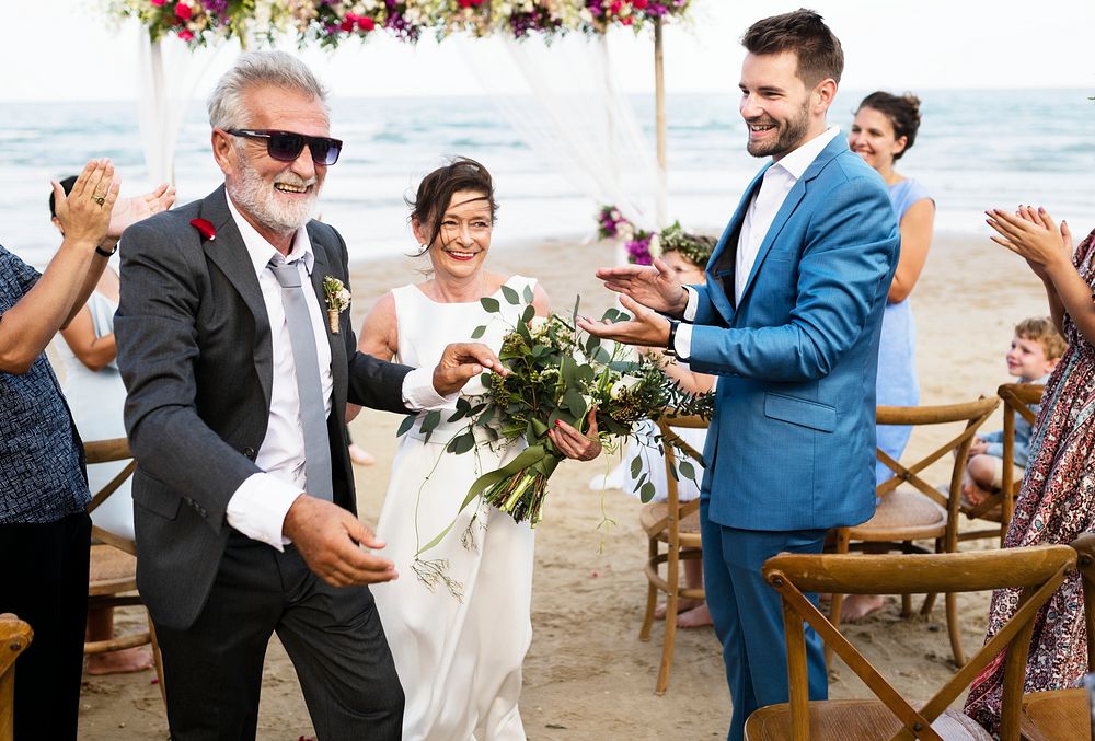 Youthful mature couple getting married at the beach