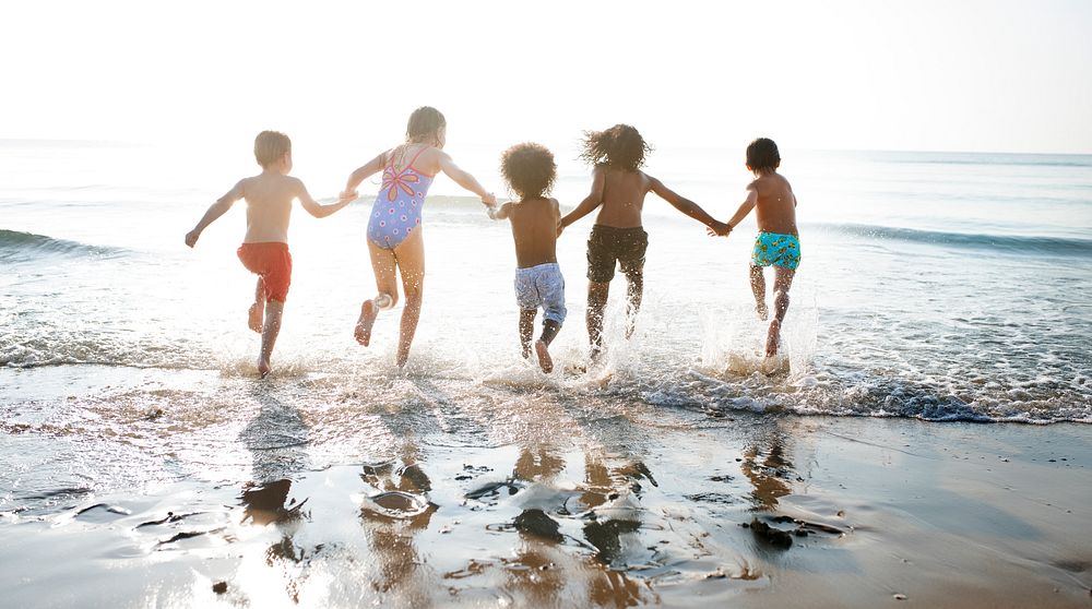 Group of kids enjoying their time at the beach